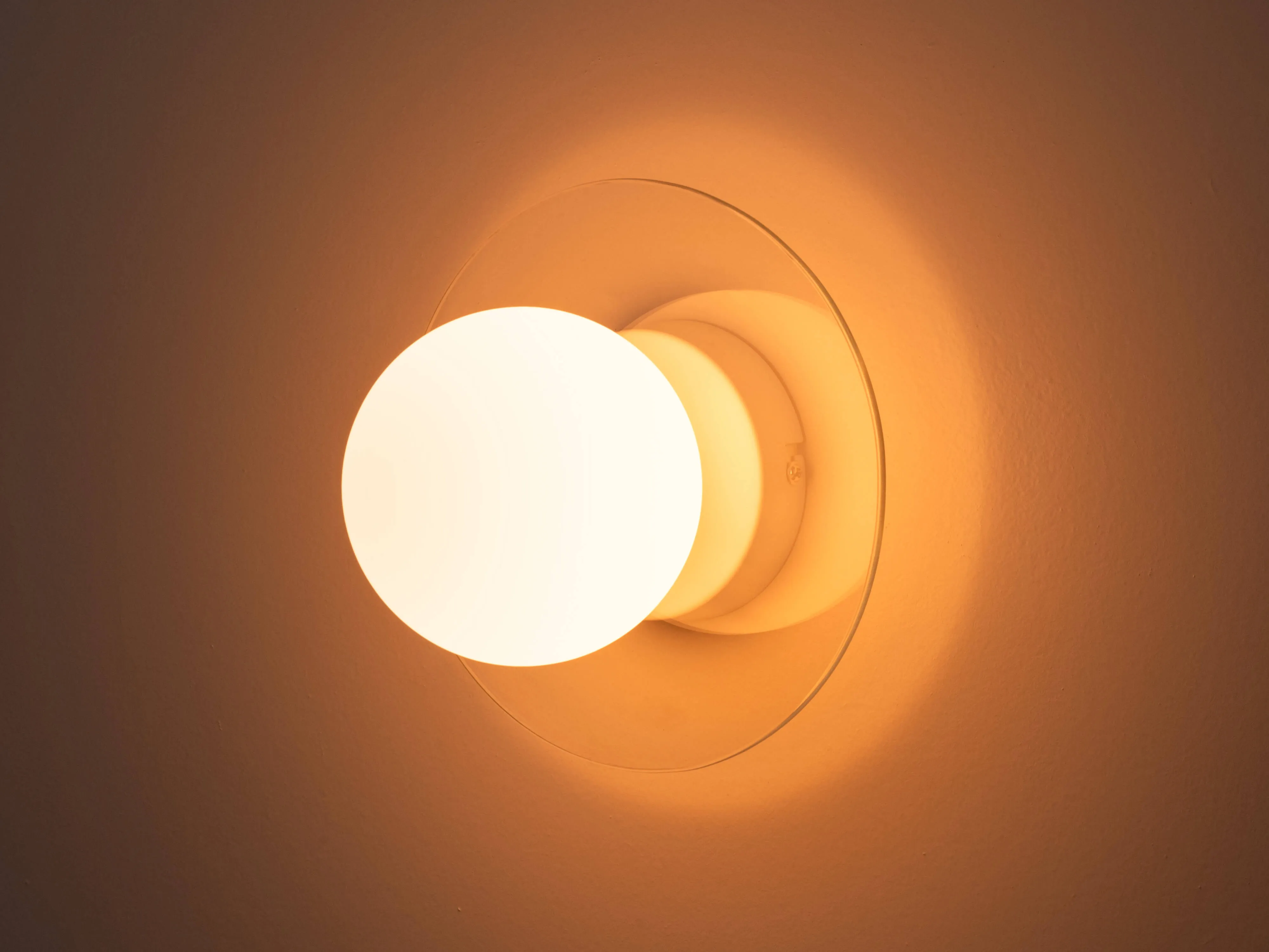 Glass opal disk wall light